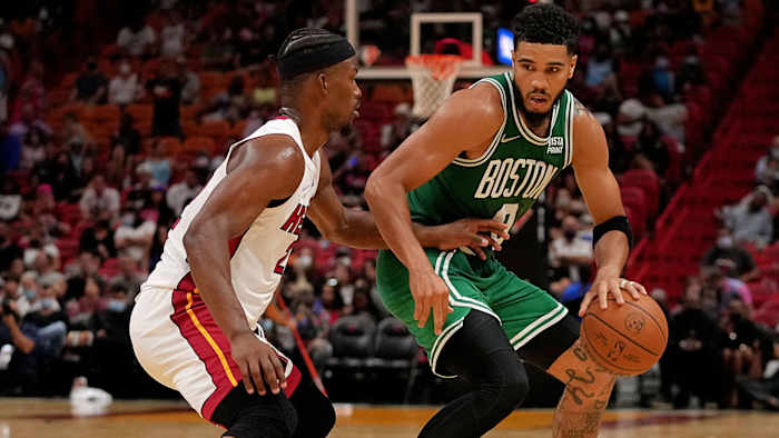 Boston Celtics forward Jayson Tatum (0) dribbles the ball around Miami Heat forward Jimmy Butler.