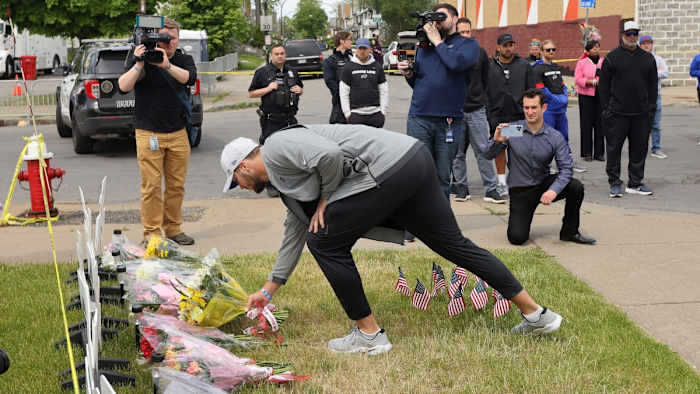 Bills quarterback Josh Allen lays flowers at a memorial near the Tops supermarket where 10 people killed in a shooting.