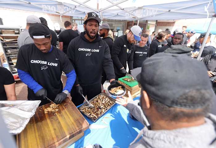 Buffalo Bills players visited the site near Tops Market in Buffalo to distribute food to members of the community.