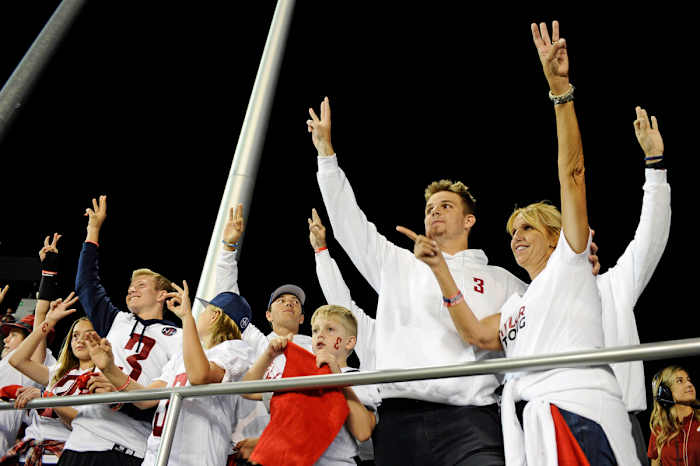 Tyler Hilinksi’s family hold up three fingers