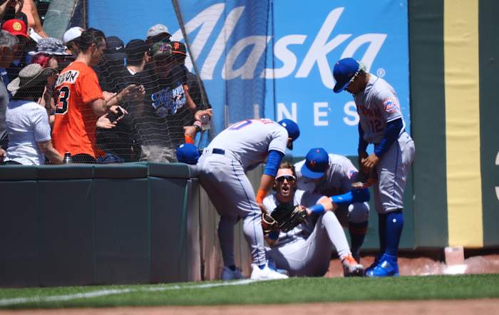 May 25, 2022; San Francisco, California, USA; Teammates check on New York Mets left fielder Jeff McNeil (1) after colliding with the wall during the third inning against the San Francisco Giants at Oracle Park.