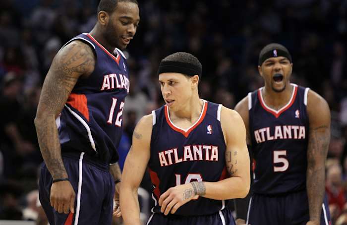 Atlanta Hawks center Josh Powell (12), point guard Mike Bibby (10), and power forward Josh Smith (5) react during the second half against the Orlando Magic at Amway Center. Atlanta Hawks defeated the Orlando Magic 80-74.
