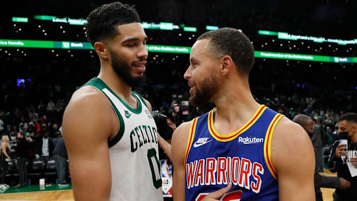 Boston Celtics forward Jayson Tatum (left) talks with Golden State Warriors guard Stephen Curry.
