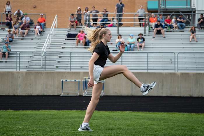Grass Lake's Lexus Bargesser warms up before competing a 200-meter dash race at Grass Lake High School on Tuesday, May 10, 2022.