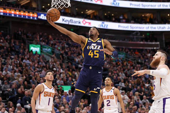 Donovan Mitchell (45) scores over Devin Booker (1) and the Phoenix Suns