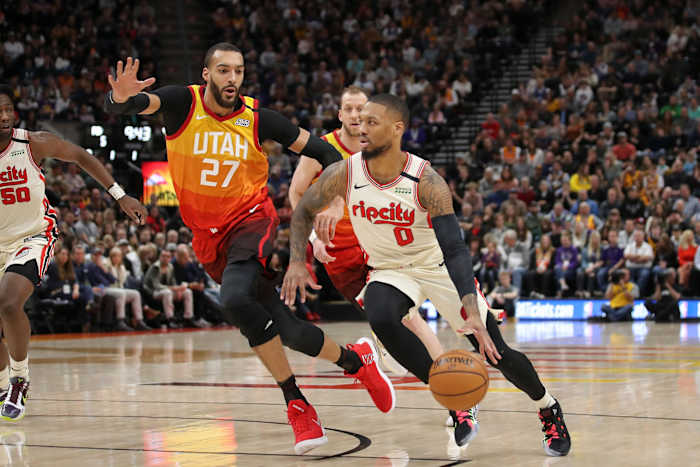 Rudy Gobert (27) guards Damian Lillard (0) in a game between the Utah Jazz and Portland Trail Blazers