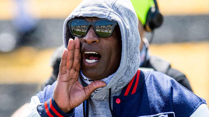 Deion Sanders yell instructions from the sideline