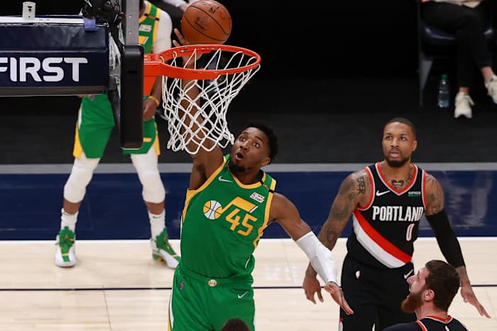 Donovan Mitchell (45) scores two points over Damian Lillard (0) and the Portland Trail Blazers