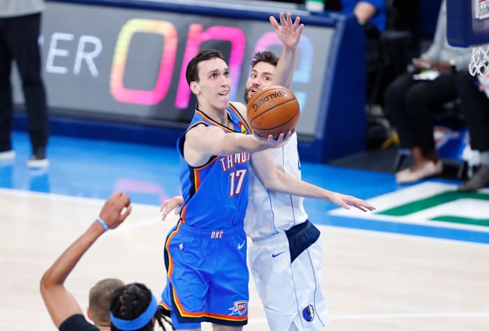 Thunder rookie Aleksej Pokusevski splits a pair of Mavericks defenders to go to the rim.