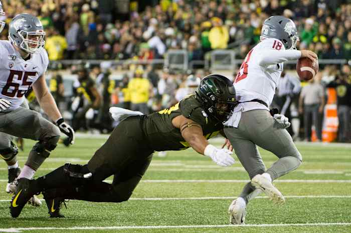 Mase Funa tackles quarterback Anthony Gordon (18) in a game against Washington State at Autzen Stadium on October 26, 2019. The Ducks would win 37-35 on a Camden Lewis field goal as time expired.
