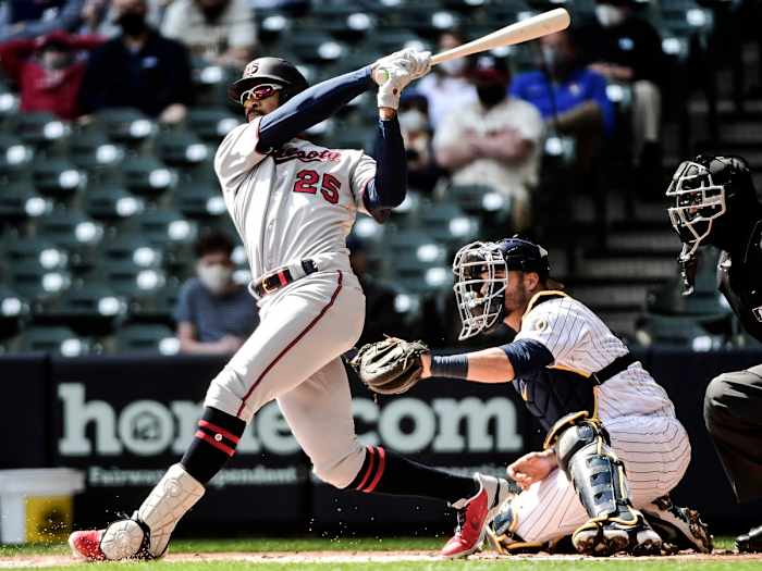 Apr 4, 2021; Milwaukee, Wisconsin, USA; Minnesota Twins center fielder Byron Buxton (25) hits a double in the first inning as Milwaukee Brewers catcher Manny Pina (9) watches at American Family Field.