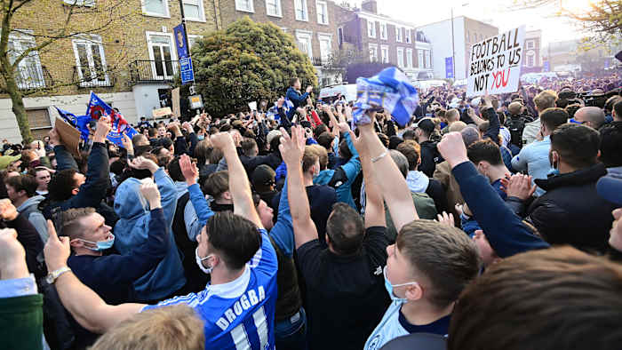 Chelsea fans celebrate the club's Super League withdrawal