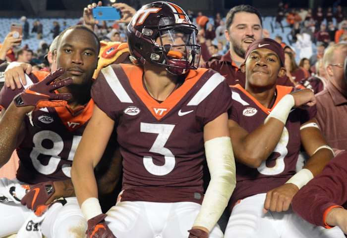 Virginia Tech Hokies defensive back Caleb Farley (3) tight end Chris Cunningham (85) and wide receiver Phil Patterson (8) celebrate with fans after a win against the North Carolina Tar Heels at Kenan Memorial Stadium. The Hokies won 22-19.