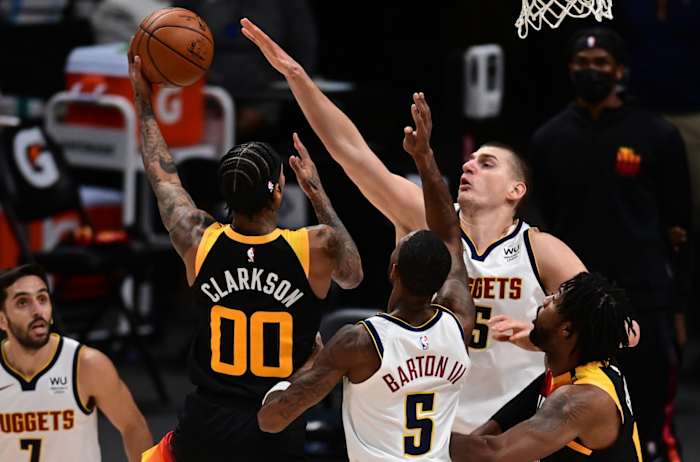 Jordan Clarkson (00) shoots over Nikola Jokic (15)
