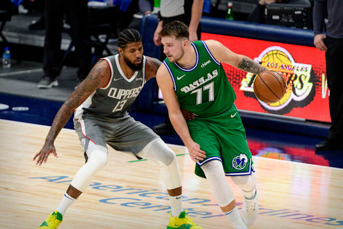Mar 17, 2021; Dallas, Texas, USA; LA Clippers guard Paul George (13) and Dallas Mavericks guard Luka Doncic (77) in action during the game between the Dallas Mavericks and the LA Clippers at the American Airlines Center. Mandatory Credit: Jerome Miron-USA TODAY Sports