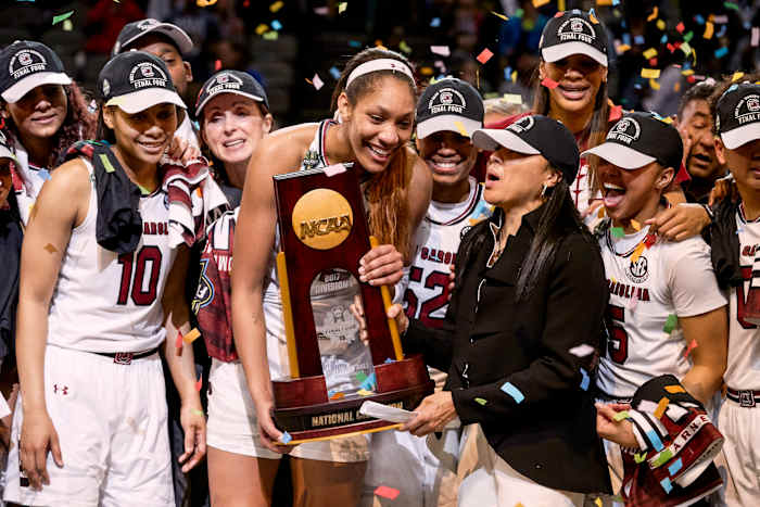Dawn Staley holds the NCAA trophy with A'ja Wilson and her teammates