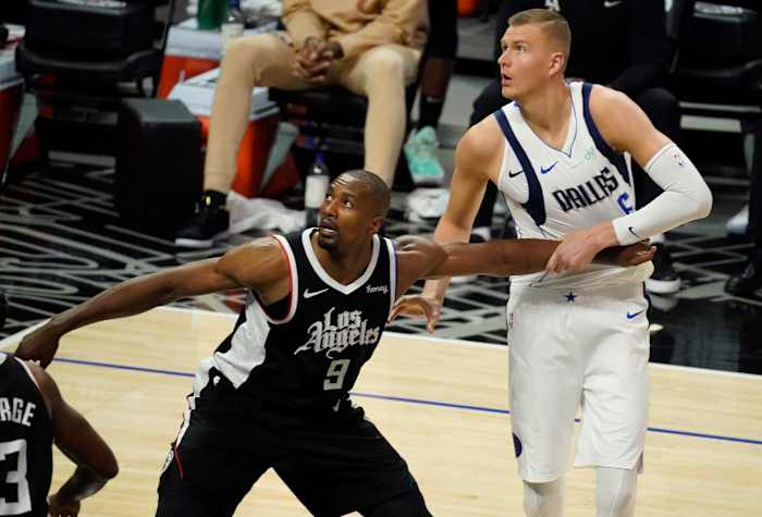 May 22, 2021; Los Angeles, California, USA; LA Clippers center Serge Ibaka (9) and Dallas Mavericks center Kristaps Porzingis (6) jockey for rebounding position during the fourth quarter of game one in the first round of the 2021 NBA Playoffs at Staples Center. Mandatory Credit: Robert Hanashiro-USA TODAY Sports