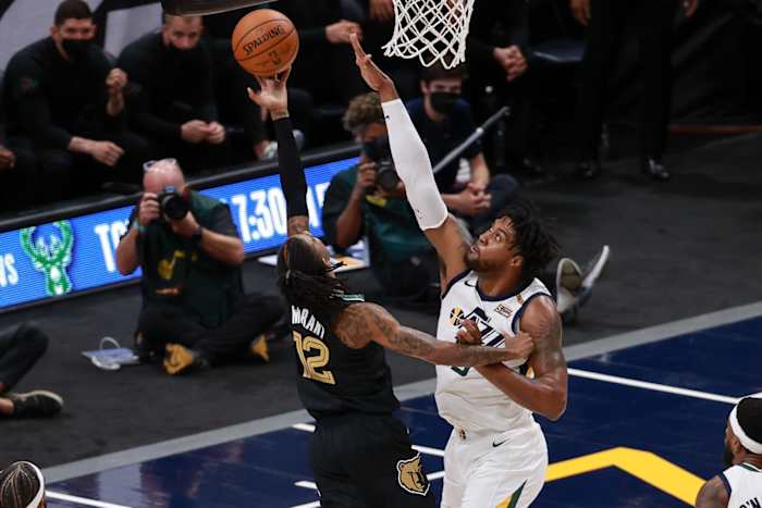 Derrick Favors (15) looks to block Ja Morant (12)