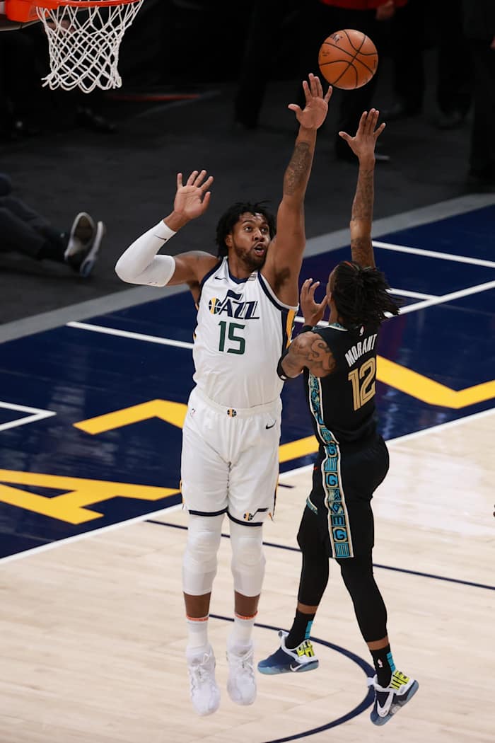 Derrick Favors (15) goes for a block against Ja Morant (12)
