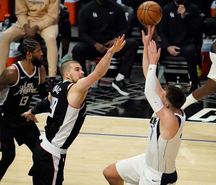 May 22, 2021; Los Angeles, California, USA; Dallas Mavericks guard Luka Doncic (77) shoots over LA Clippers center Ivica Zubac (40) during the third quarter of game one in the first round of the 2021 NBA Playoffs at Staples Center. Mandatory Credit: Robert Hanashiro-USA TODAY Sports