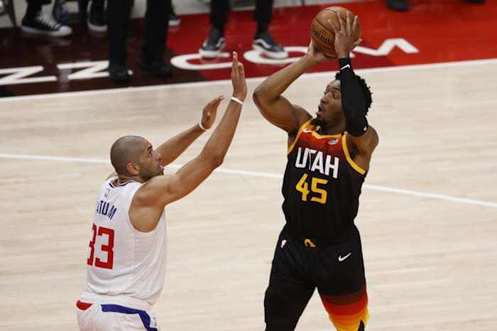 Donovan Mitchell (45) scores over Nicolas Batum (33)