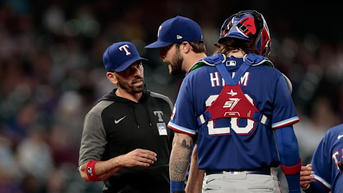 Jun 2, 2021; Denver, Colorado, USA; Texas Rangers starting pitcher Jordan Lyles (24) is pulled by manager Chris Woodward (8) ahead of catcher Jonah Heim (28) in the sixth inning against the Colorado Rockies at Coors Field.