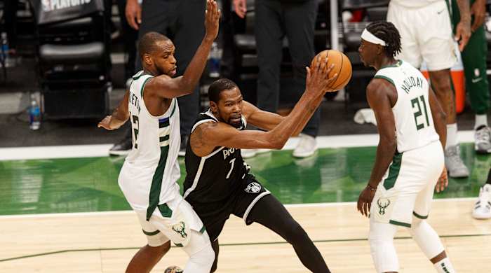 Khris Middleton, Kevin Durant and Jrue Holiday
