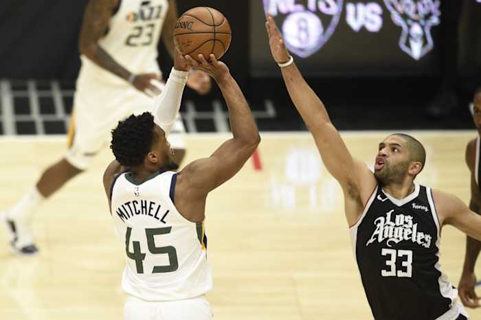 Donovan Mitchell (45) shoots a three pointer over Nicolas Batum (33)