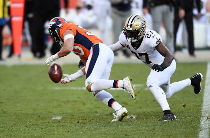 Denver Broncos running back Phillip Lindsay (30) fumbles against New Orleans Saints safety Malcolm Jenkins (27). Mandatory Credit: Ron Chenoy-USA TODAY
