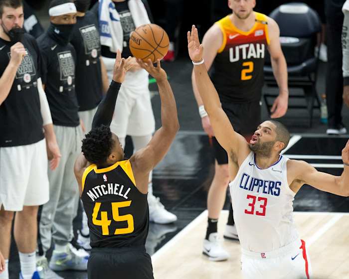 Donovan Mitchell (45) shoots a three pointer over Nicolas Batum (33)