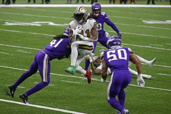 New Orleans Saints running back Alvin Kamara (41) jumps into the end zone between Minnesota Vikings Anthony Harris (41) and Eric Wilson (50). Mandatory Credit: Chuck Cook-USA TODAY Sports