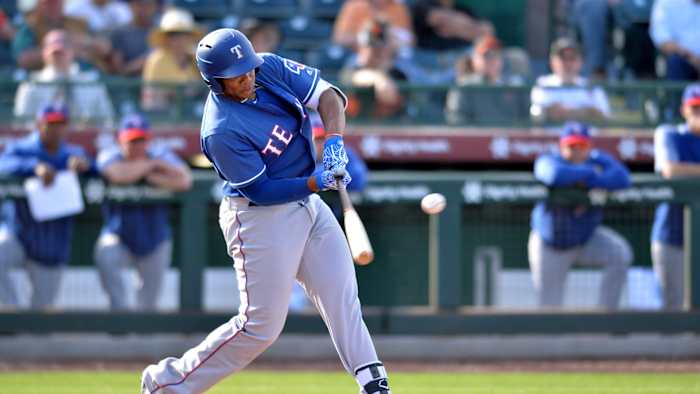 Mar 10, 2019; Scottsdale, AZ, USA; Texas Rangers infielder Curtis Terry (30) hits an RBI single during the ninth inning against the San Francisco Giants at Scottsdale Stadium.