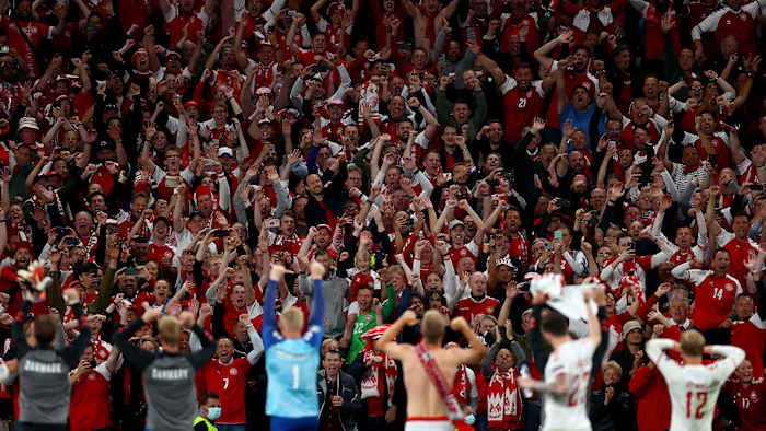 Denmark fans celebrate with players at Parken Stadium
