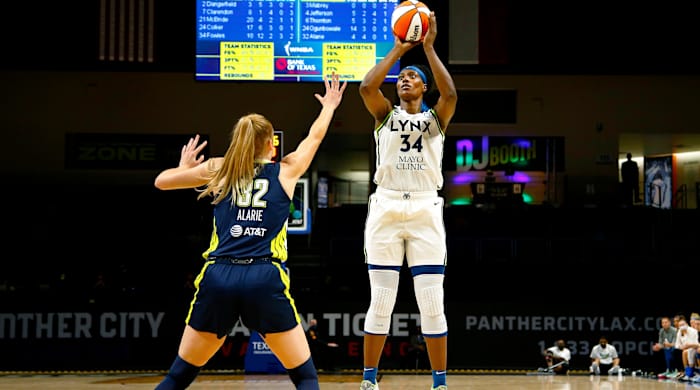 Sylvia Fowles shooting the basketball over a Dallas Wings player