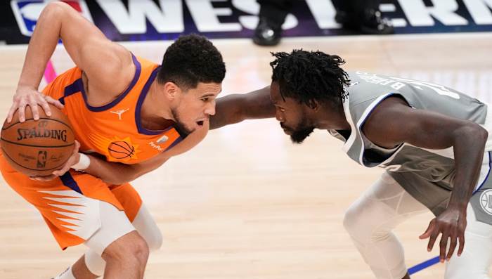 Jun 26, 2021; Los Angeles, California, USA; Phoenix Suns guard Devin Booker (1) and LA Clippers guard Patrick Beverley (21) face off during the fourth quarter of game four of the Western Conference Finals for the 2021 NBA Playoffs at Staples Center. Mandatory Credit: Robert Hanashiro-USA TODAY Sports