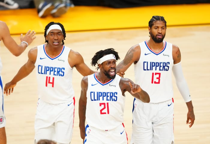 Jun 22, 2021; Phoenix, Arizona, USA; Los Angeles Clippers guard Patrick Beverley (21) celebrates with Paul George (13) and Terance Mann (14) against the Phoenix Suns in the second half during game two of the Western Conference Finals for the 2021 NBA Playoffs at Phoenix Suns Arena. Mandatory Credit: Mark J. Rebilas-USA TODAY Sports