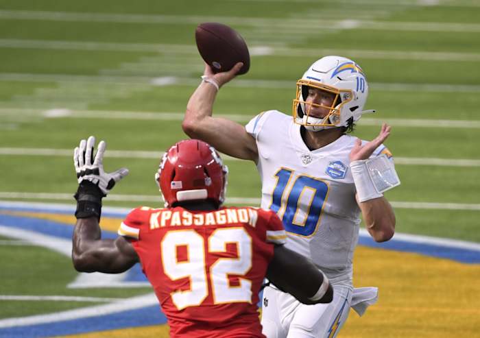 Chargers quarterback Justin Herbert (10) throws a pass against Kansas City defensive end Tanoh Kpassagnon (92). Mandatory Credit: Robert Hanashiro-USA TODAY