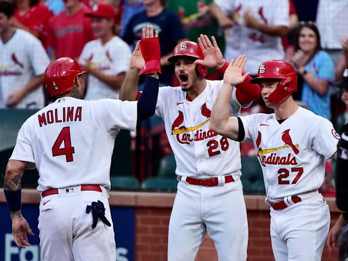 Jun 9, 2021; St. Louis, Missouri, USA; St. Louis Cardinals third baseman Nolan Arenado (28) and left fielder Tyler O'Neill (27) and catcher Yadier Molina (4) celebrate after they scored on a double by second baseman Matt Carpenter (not pictured) during the first inning against the Cleveland Indians at Busch Stadium.