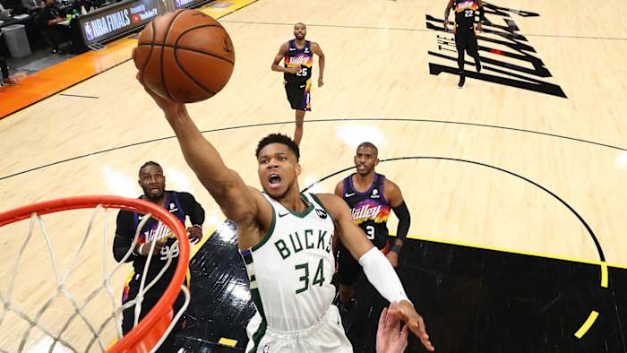Milwaukee Bucks forward Giannis Antetokounmpo (34) moves in for a basket ahead of Phoenix Suns forward Jae Crowder.