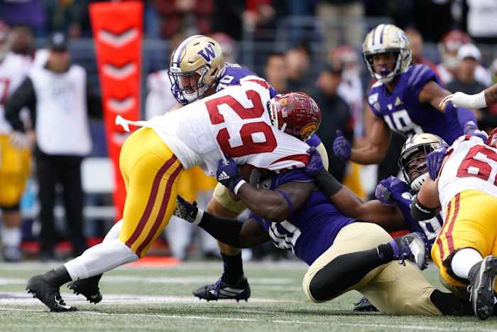 Washington Huskies linebacker Kyler Manu (30), defensive lineman Josiah Bronson (90) combine to stop USC running back Vavae Malepeai (29). Mandatory Credit: Jennifer Buchanan-USA TODAY
