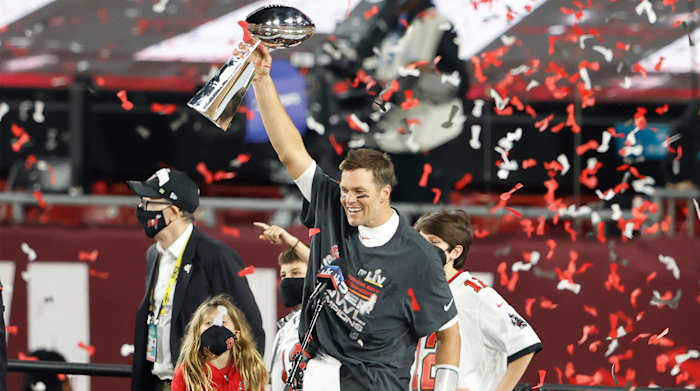 Feb 7, 2020; Tampa, FL, USA; Tampa Bay Buccaneers quarterback Tom Brady (12) lifts the Lombardi Trophy after Super Bowl LV at Raymond James Stadium.