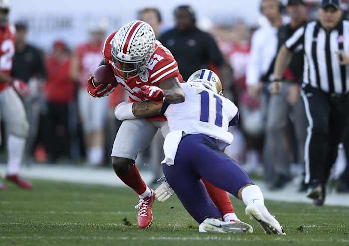 Jan 1, 2019; Pasadena, CA, USA; Washington Huskies defensive back Brandon McKinney (11) tackles Ohio State Buckeyes wide receiver Parris Campbell (21)in the 2019 Rose Bowl at Rose Bowl Stadium. Mandatory Credit: Kelvin Kuo-USA TODAY Sports