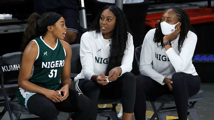 Erica Ogwumike (31) chats with sisters Chiney Ogwumike (center) and Nneka Ogwumike (right) during Nigeria's exhibition loss to U.S. women's basketball