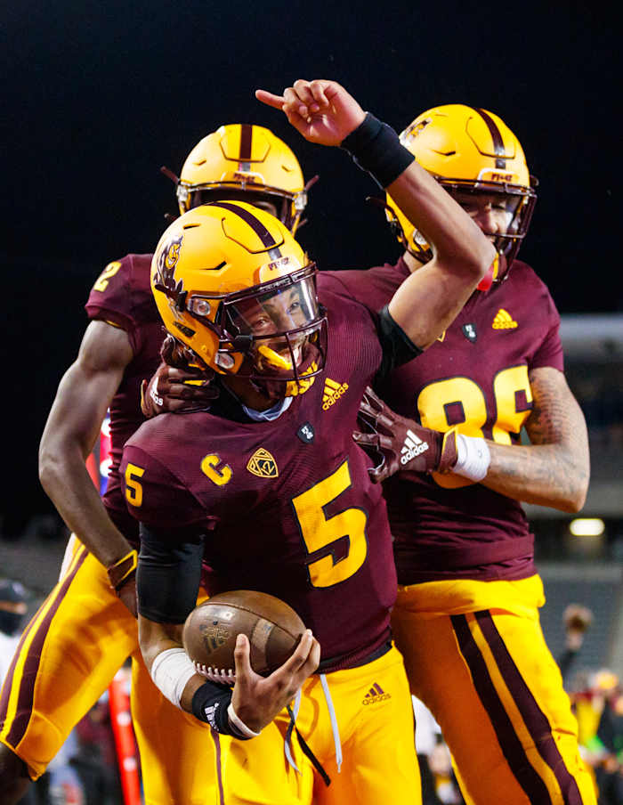 Daniels celebrates with teammates in a game against the Arizona Wilcats.