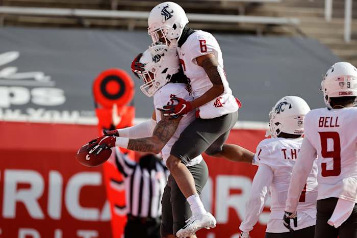 Deon McIntosh (3) celebrates a touchdown with wide receiver Jamire Calvin (6).