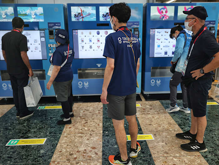 People wander outside of Tokyo Olympics vending machine