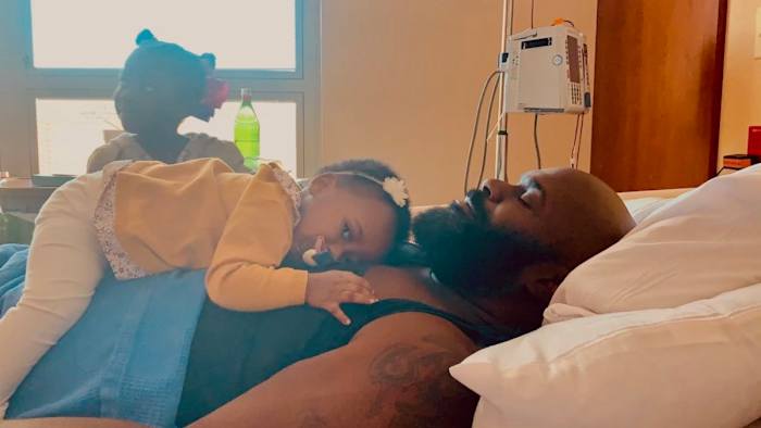 Dalton and his two daughters, Skye and Sade, together as he receives dialysis.