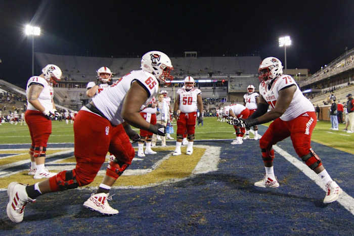 Nov 21, 2019; Atlanta, GA, USA; North Carolina State Wolfpack offensive lineman Timothy McKay (65) and offensive lineman Ikem Ekwonu (79) warm up before a game against the Georgia Tech Yellow Jackets at Bobby Dodd Stadium.