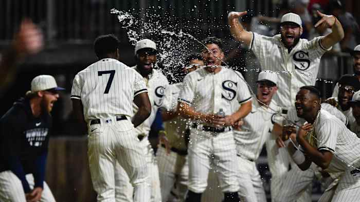 Tim Anderson's teammates celebrate as he crosses home plate