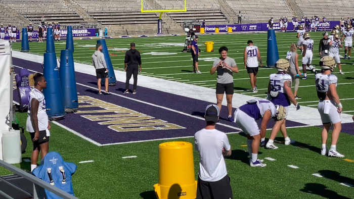 Laiatu Latu has a football in his hands as practice spectator.
